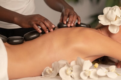 Woman wearing white towel during hot stone massage