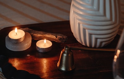 candle snuffer, two tea-lights and the vase on the table