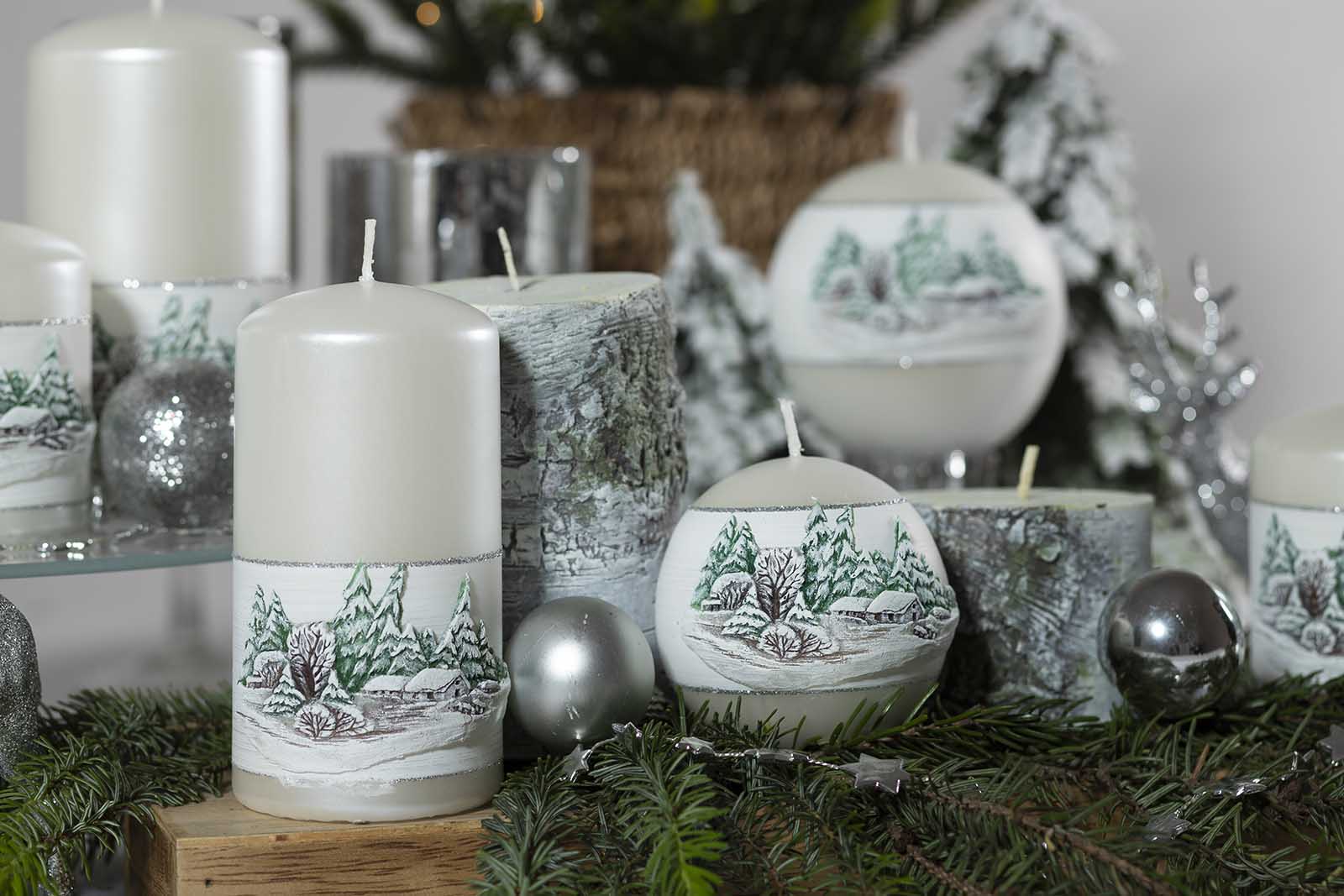 Three Pillar and two round candles with winter theme surrounded by pine leaves and two Pine tree logs shaped pillar candles